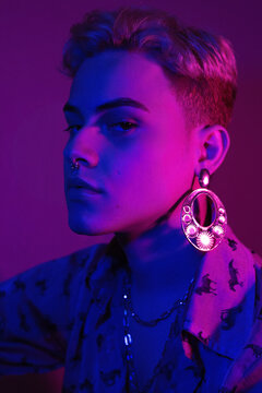 Brazilian Man In Floral Button Up Shirt With Gold Hoop Earrings