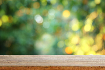 Empty wooden table in front of orange field