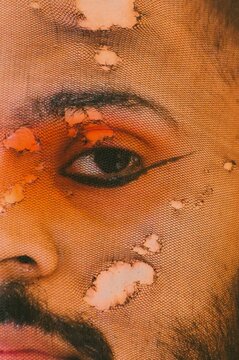 Close-up shot of man wearing undereye eyeliner