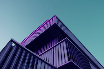 Low angle view of purple building under blue sky