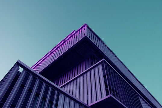 Low Angle View Of Purple Building Under Blue Sky