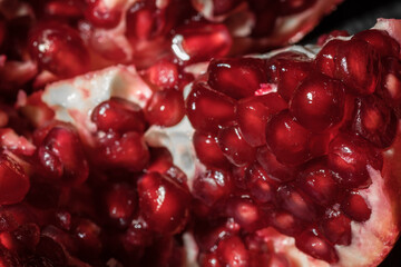 Juicy and ripe pomegranate seeds. Macrophotography. Red pomegranate seeds close-up.
