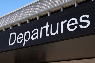 Departures sign at the entrance of an airport.
