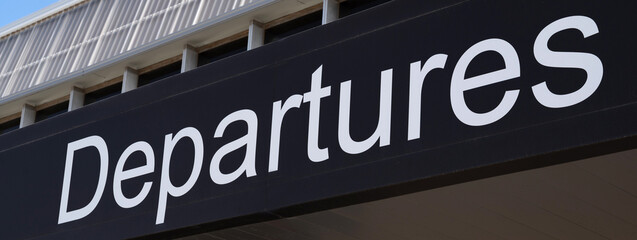 Horizontal banner or header Departures sign at the entrance of an airport.