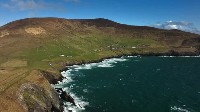 Coumeenoole Bay, Kerry, Ireland, March 2022. Drone orbits the cliffs at Dunmore head on the Dingle Peninsula while facing east towards Glanfahan and Ventry.