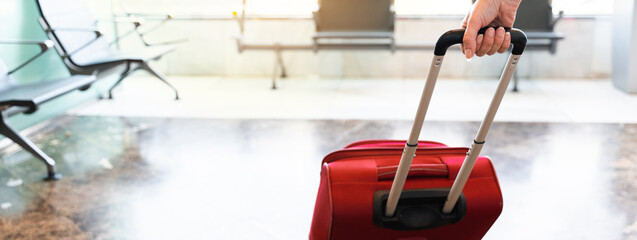 Horizontal banner or header Close-up trolley at the airport with unrecognizable female hand waking...