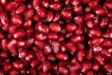 Juicy and ripe pomegranate seeds. Macrophotography. Red pomegranate seeds close-up.