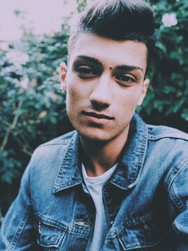Portrait of brunette man in blue denim jacket