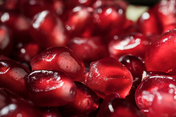 Juicy and ripe pomegranate seeds. Macrophotography. Red pomegranate seeds close-up.