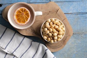 top view of hazelnuts in bowl. Hazelnut with nutcracker on olive wooden board. Nuts with green leaves. Top view.