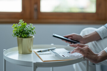 Close up hand of accountant working with computer and calculator for business and financial expense.