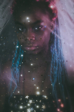 Portrait of young Black woman with colorful dreads in Nebula themed studio