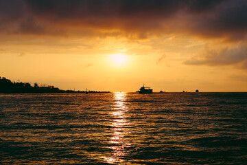 Fototapeta na wymiar Sunset at sea. Orange sun, summer. Ships. High quality photo