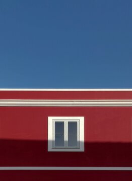 Red and white house under blue sky