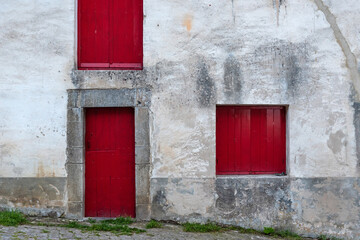 Old rural facade door and red windows