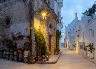 Monopoli - The old town aisle with the little chapel at dusk.