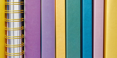 Close-up of book spines. Empty colorful book spines background texture.