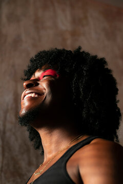 Smiling Man Wearing Red Eyeshadow