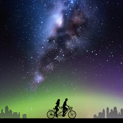 Fototapeta na wymiar Couple on bike tandem in park. Cyclist on bicycle. Milky Way at night