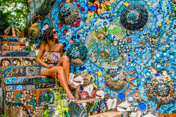 Woman sitting on colorful mosaic steps�in Honduras