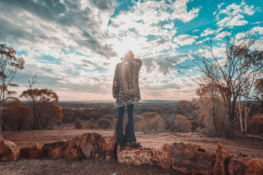Woman watching sunset over outback desert