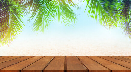 Empty wood table top with sunny tropical beach with palm trees background. Summer background concept