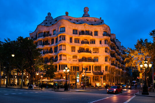 BARCELONA, SPAIN - APRIL 17, 2019: Night view of famous Casa Mila house know as La Pedrera modernist building in Barcelona, Catalonia, Spain designed by architect Antoni Gaudi