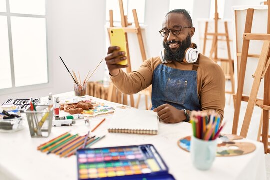 Young african american artist man making selfie by the smartphone at art studio.