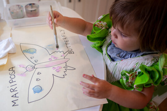 Young girl drawing a butterfly