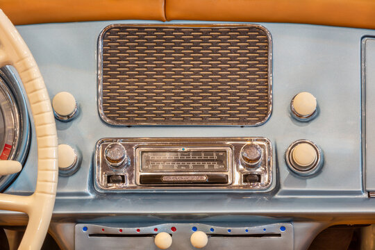 Old car radio with speaker inside a classic American car