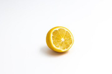 One cut citrus fruit a hybrid of orange and lemon yellow color on a white background