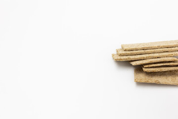 A few dry wheat diet light thin small loaves of bread on a white background isolated