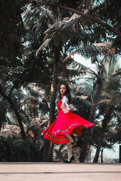 Young woman dancing in red dress
