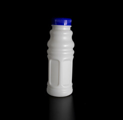 white juice bottle isolate on black background