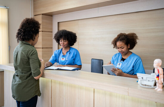 Doctor and reception talking with a patient at hospital. Health and wellness.