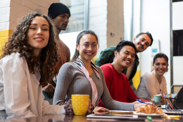 Young co-workers or university students multiethnic team planning a new startup - Bright filter with focus on second woman face on left