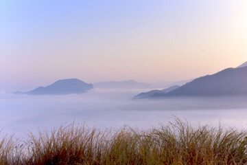 Beautiful scene view of misty in the morning over the mountains at sunrise time at Phu thok. a popular tourist attraction of Chiang Khan District, Loei Province in Thailand.