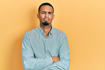 Young african american man wearing casual clothes skeptic and nervous, disapproving expression on face with crossed arms. negative person.