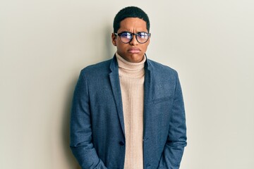 Young handsome hispanic man wearing elegant clothes and glasses depressed and worry for distress, crying angry and afraid. sad expression.