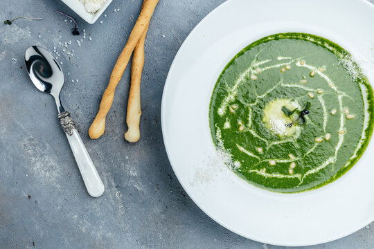 Broccoli, spinach cream soup in a bowl, egetarian dish. banner, Food recipe background. Close up