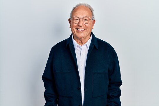 Senior man with grey hair wearing casual style and glasses with a happy and cool smile on face. lucky person.