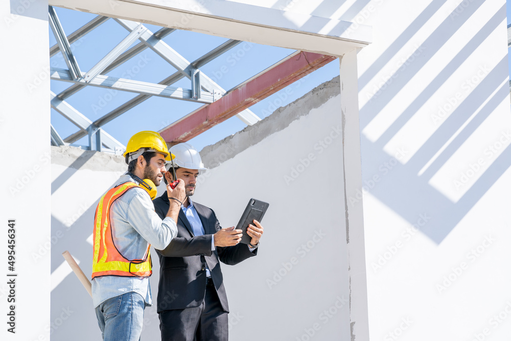 Leinwandbilder Engineers are discussing data working and tablet or laptop with architectural project at new construction site,Engineering tools and construction concept.