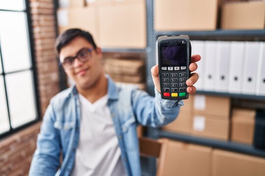Down syndrome man ecommerce business worker holding data phone at office