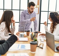 Group of business workers listening boss directions working at the office.