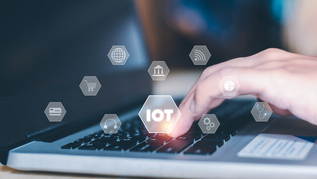 IoT internet of thing concept. Businessmen use a laptop with an interface popup of icons such as earth, wifi, internet banking, credit card, data, telemedicine, and online shopping.