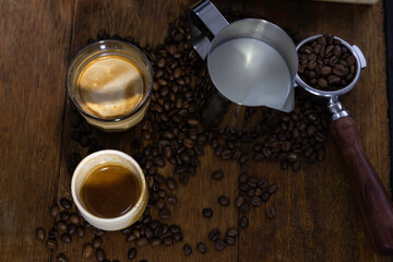 Coffee cup espresso shot and dirty coffee put on wooden table with spread coffee bean.