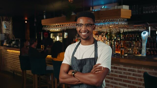 African American waiter getting ready for work in restaurant 