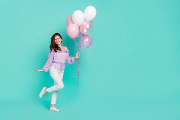 Fototapeta na wymiar Full body photo of nice cheerful person arm hold air balloons toothy smile isolated on teal color background