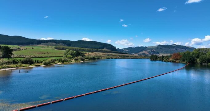 Flight over majestic Lake Whakamaru close to lush farmland - New Zealand