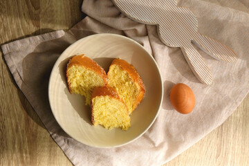 Plate of traditional sweet bread, eaten at Easter time in Croatia. Easter bunny, eggs and flowers on the table. Top view.